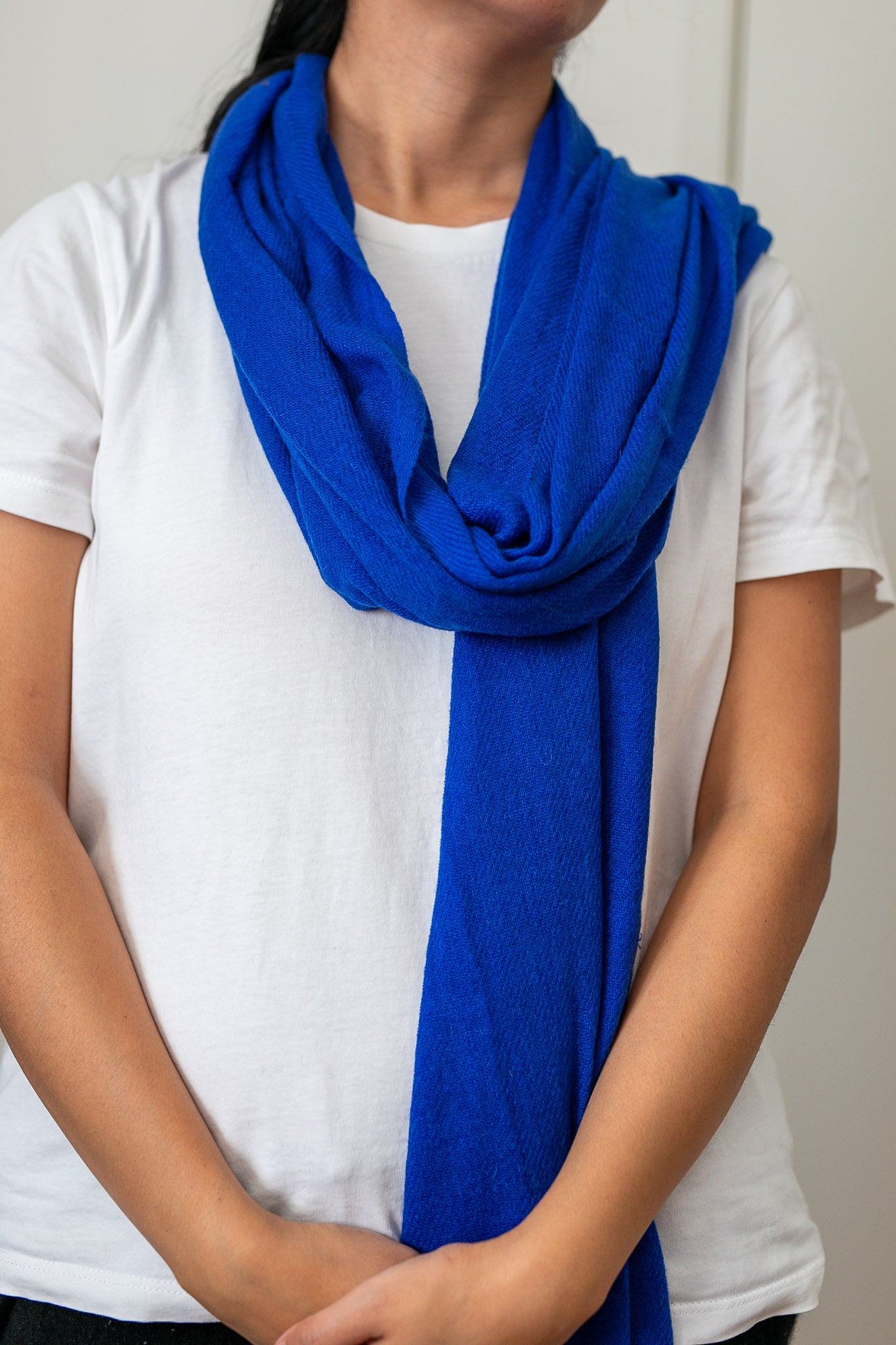 Blue cashmere shawl scarf wrapped around the neck