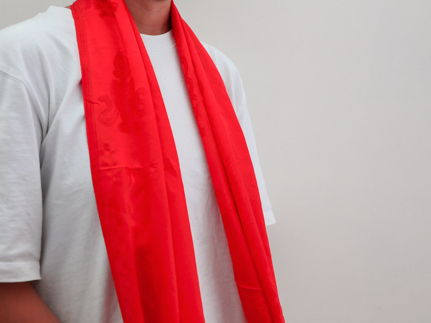 red khata khada ceremonial scarf worn around neck