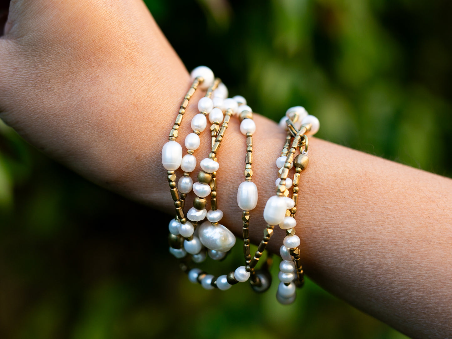 Detail in pearl and brass necklace