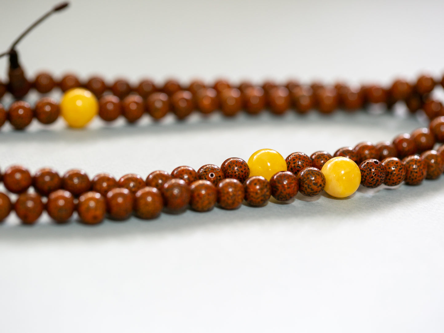 close up of lotus seed and amber mala beads