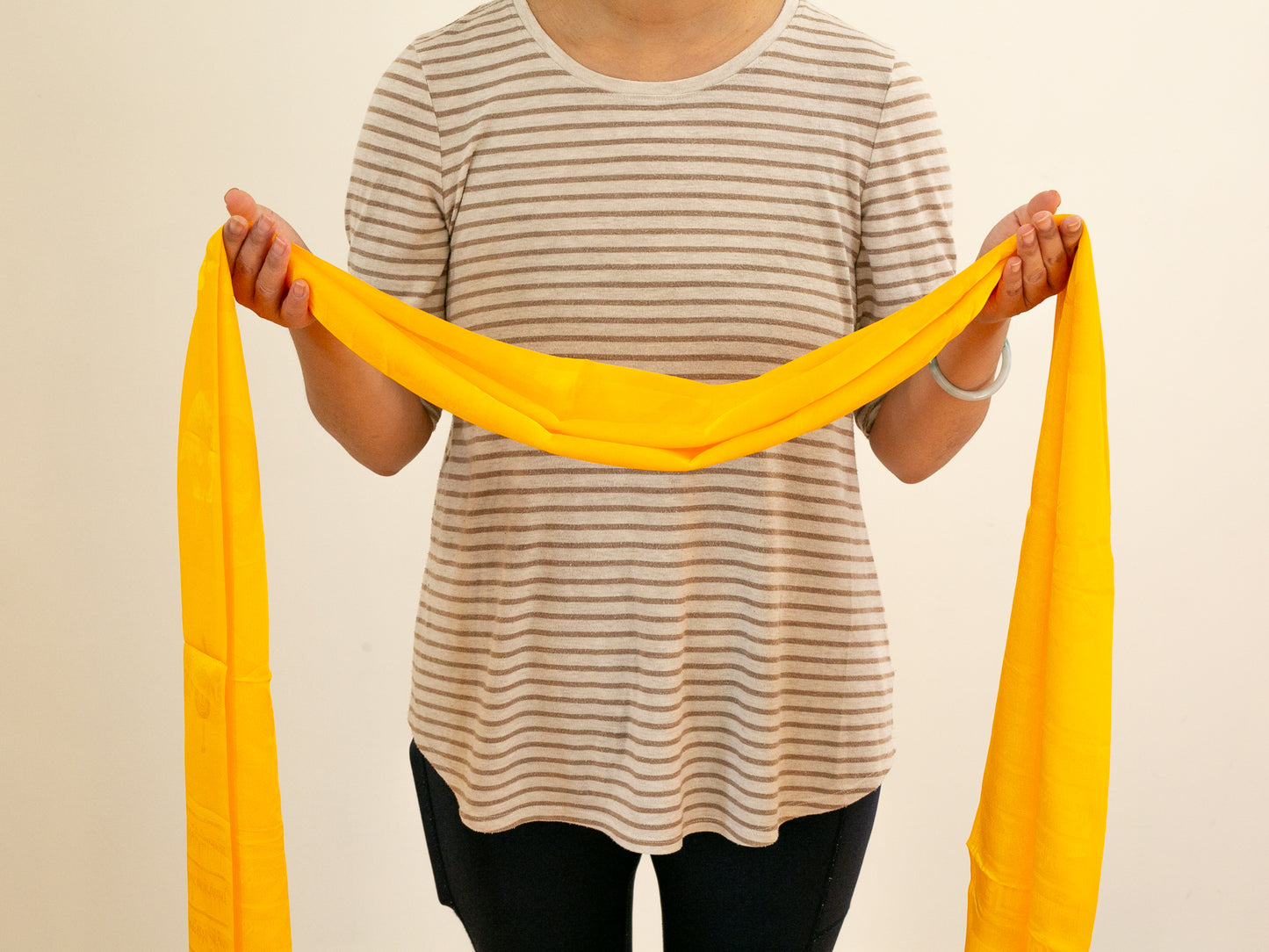 Yellow khata held with open arms