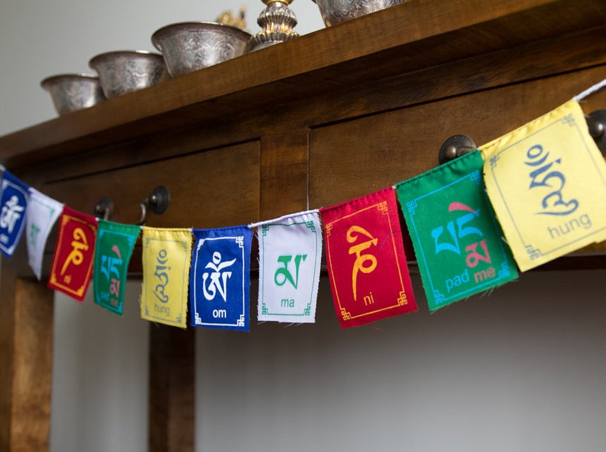 Compassion mantra om mani padme hung prayer flag on altar