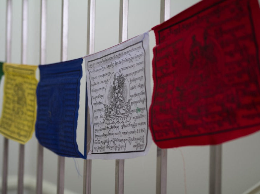 Wind horse Tibetan prayer flag on fence