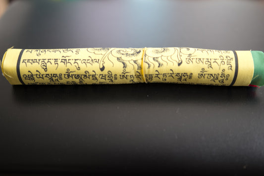 Close up of rolled wind horse lungta prayer flag
