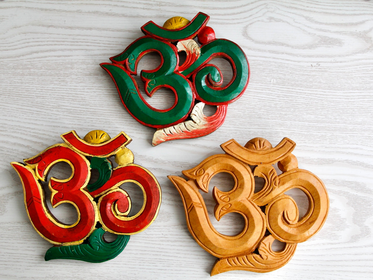 three variants of small Om wall hanging