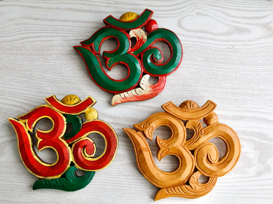 three variants of small Om wall hanging