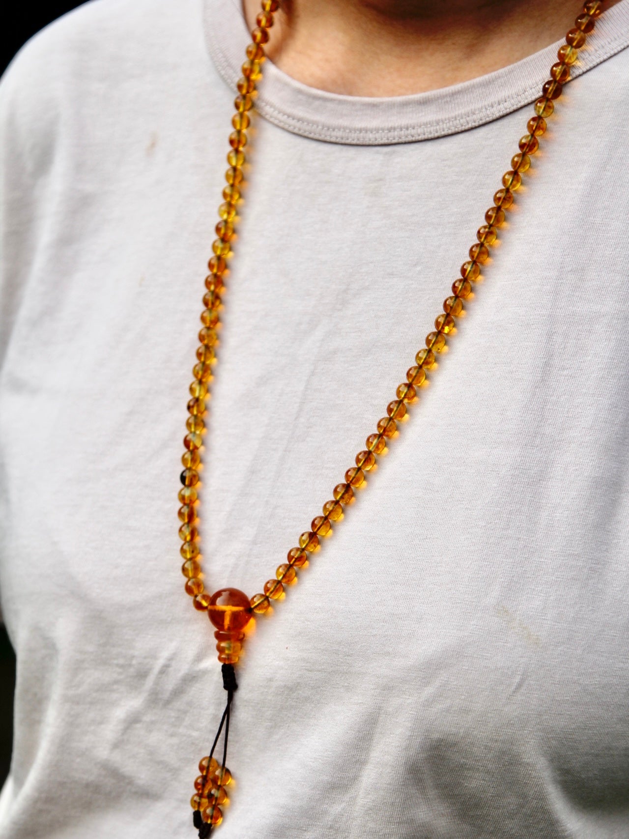 Another photo of amber mala worn around neck