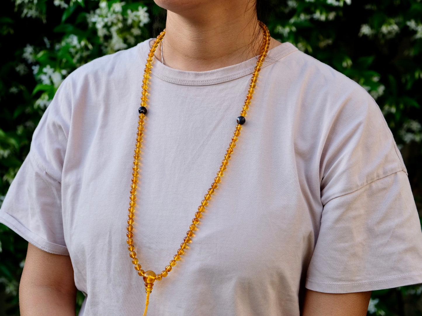 Honey amber mala worn around neck