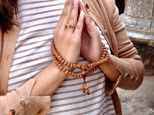 8 face rudraksha mala wrapped around hands