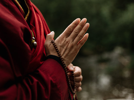 Mala beads in monk's hand