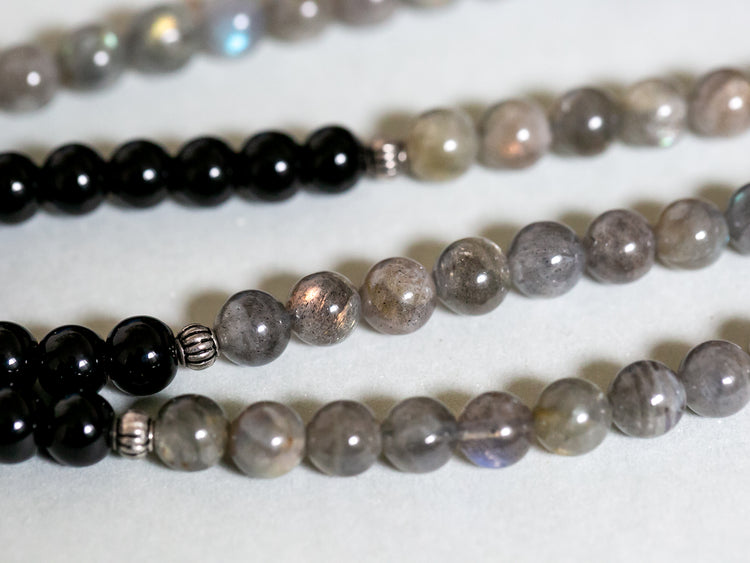 Labradorite and black onyx mala beads reflecting light