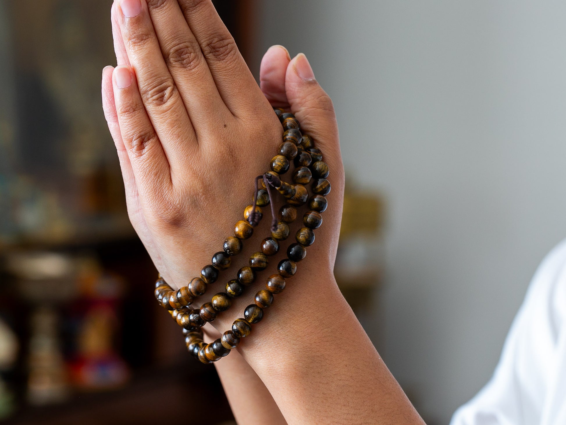 tiger eye mala with 108 beads wrapped around hand