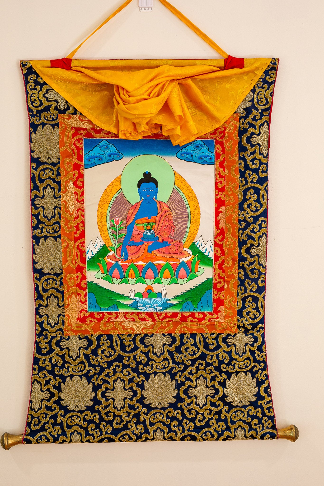 Medicine Buddha thangka against white wall