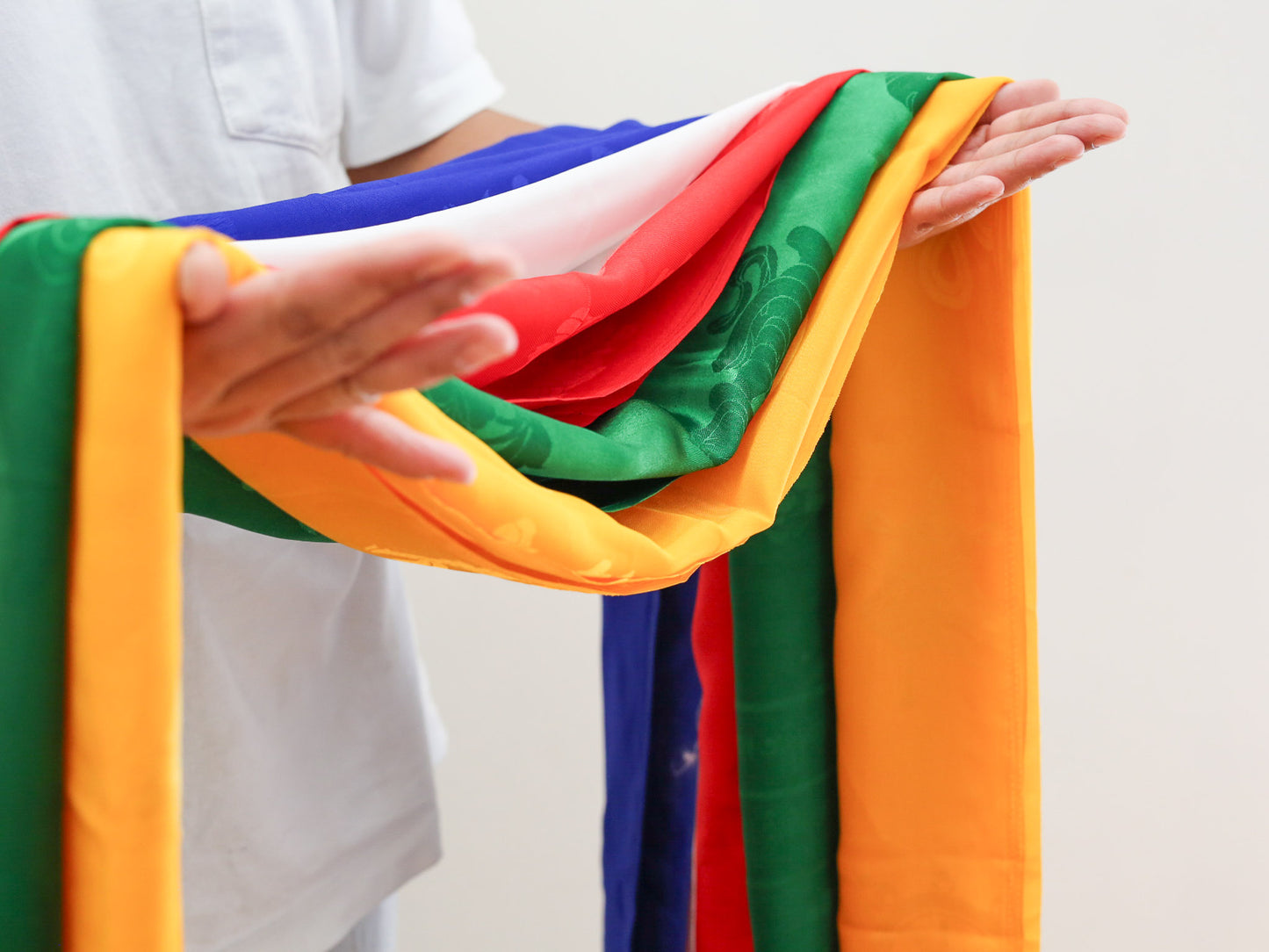 set of five khata khada scarves held in hands as an offering