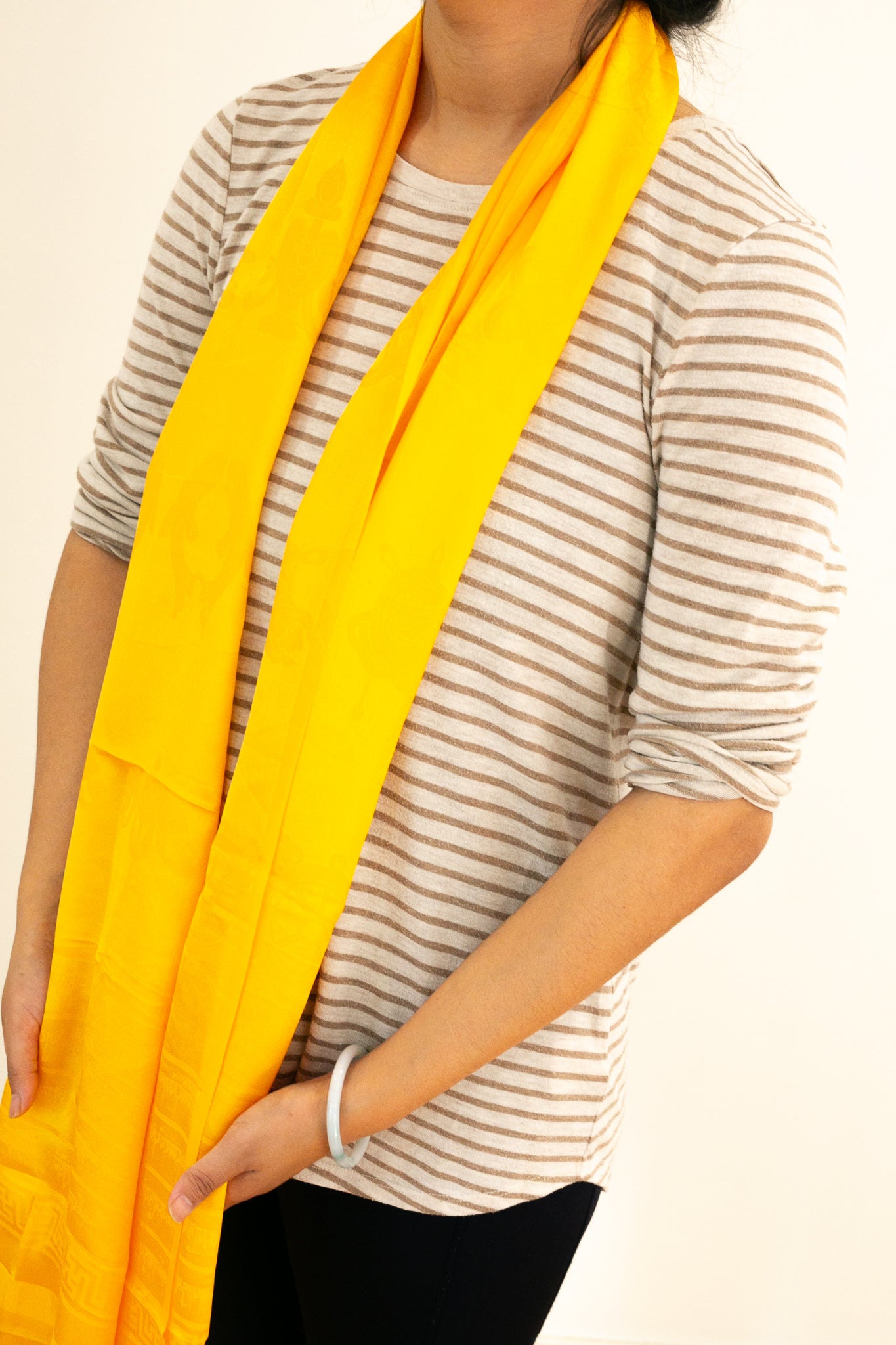 yellow khada worn around the neck in portrait mode