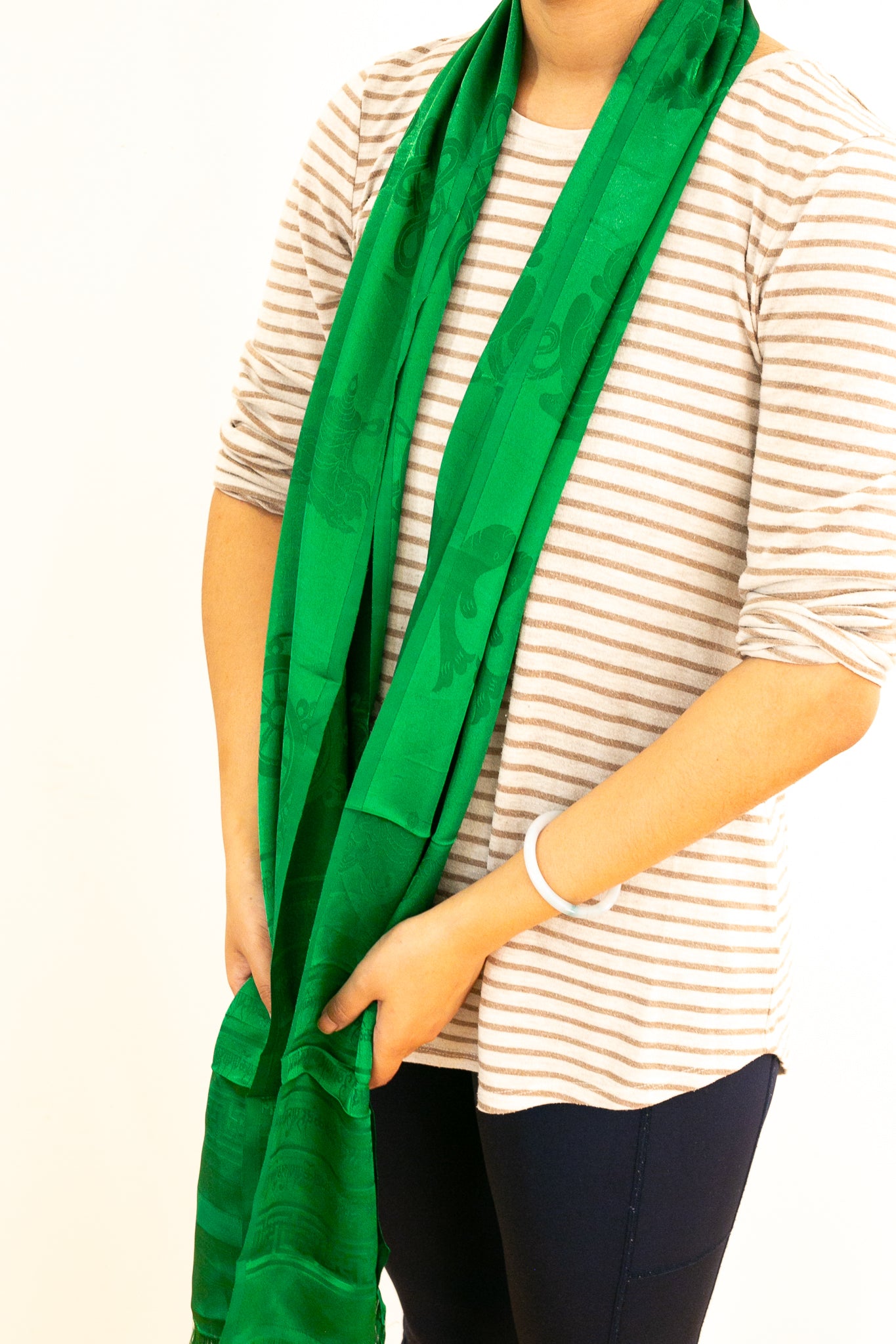 Green khada being worn around the neck