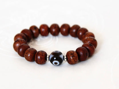 Custom Bodhi Mala bracelet against white background with dzi feature bead