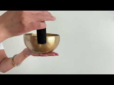 tibetan singing bowl being played
