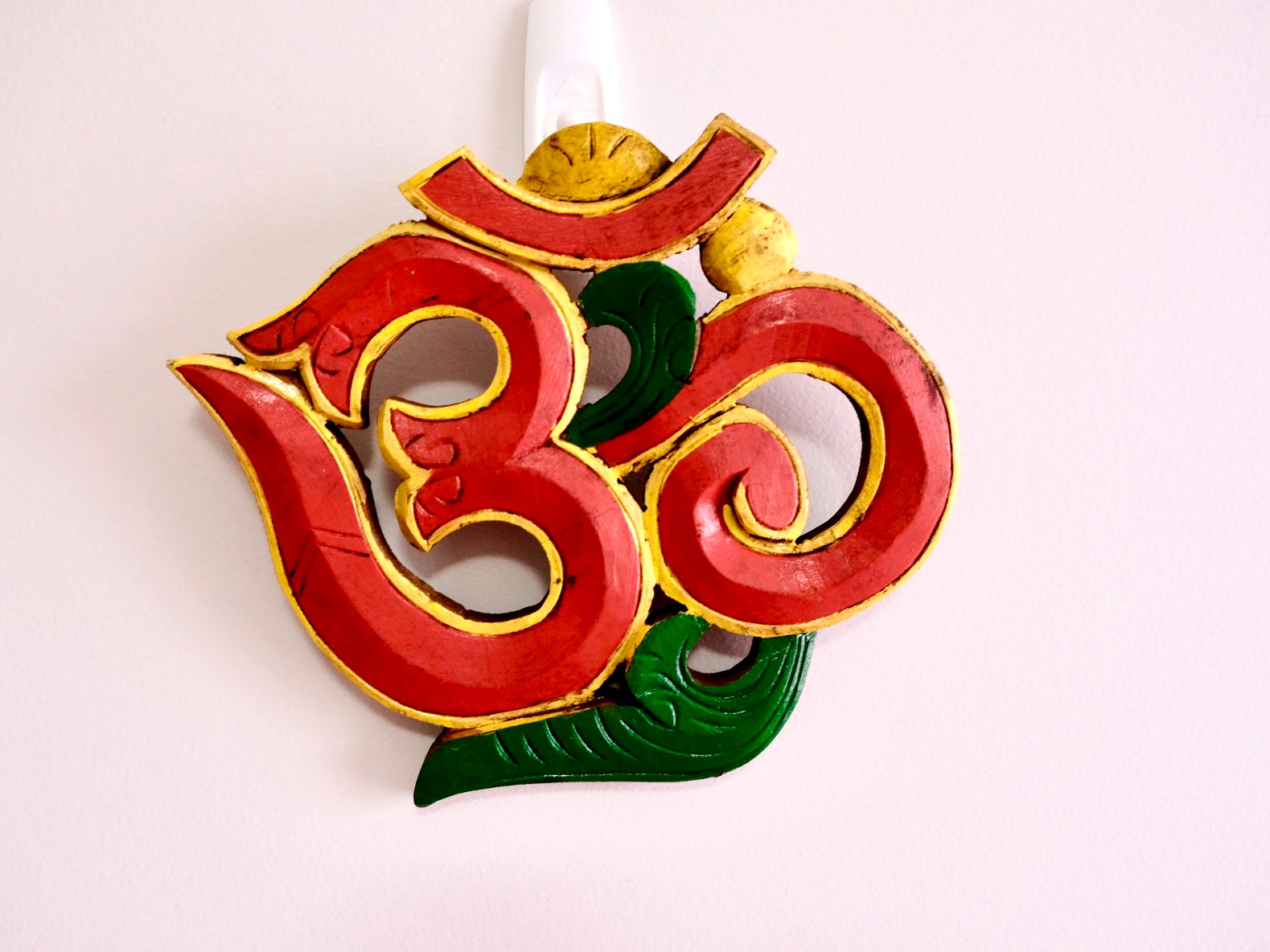 red Om decorative wall hanging with yellow border