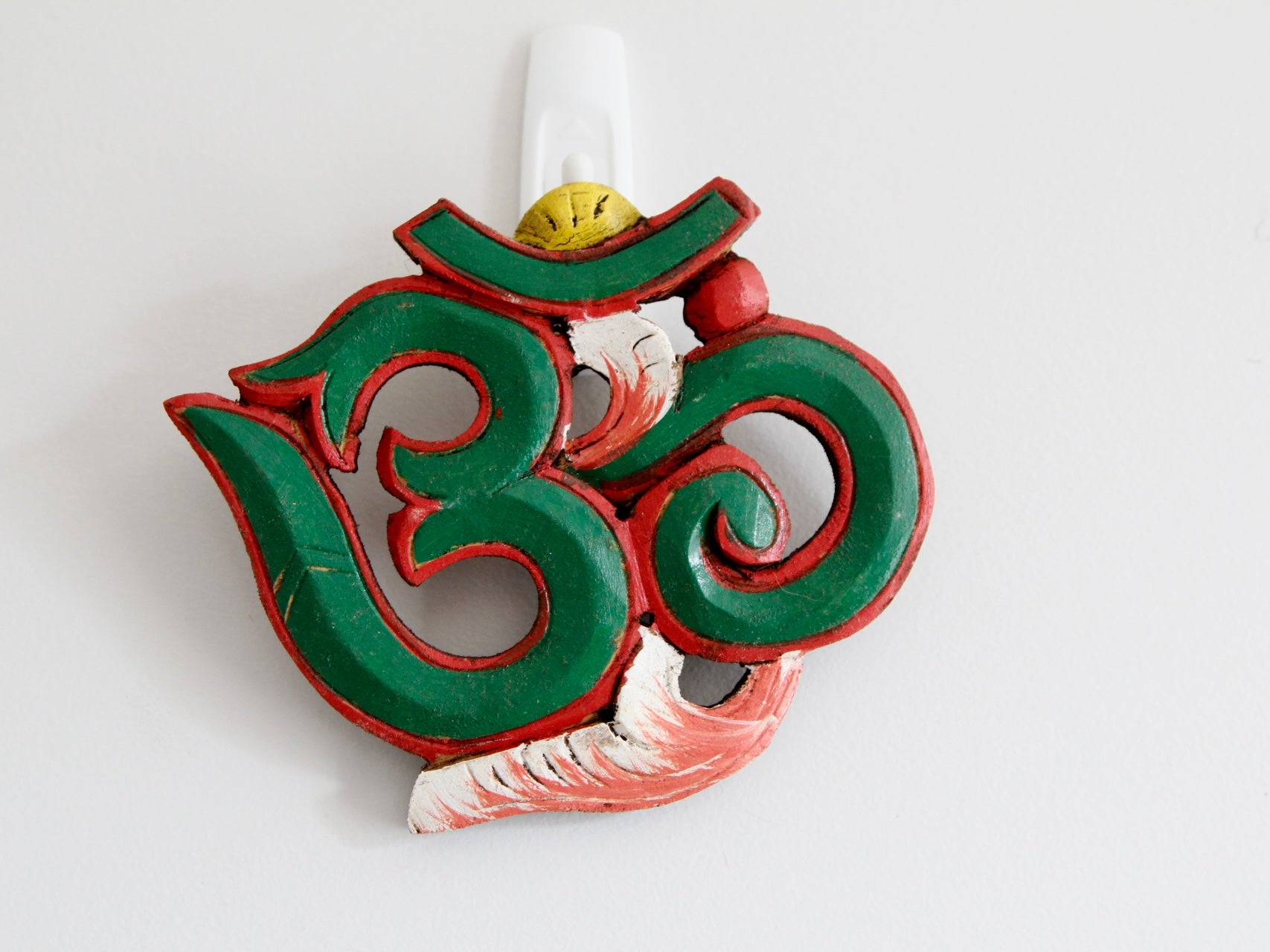 Green variant of Om wooden wall hanging