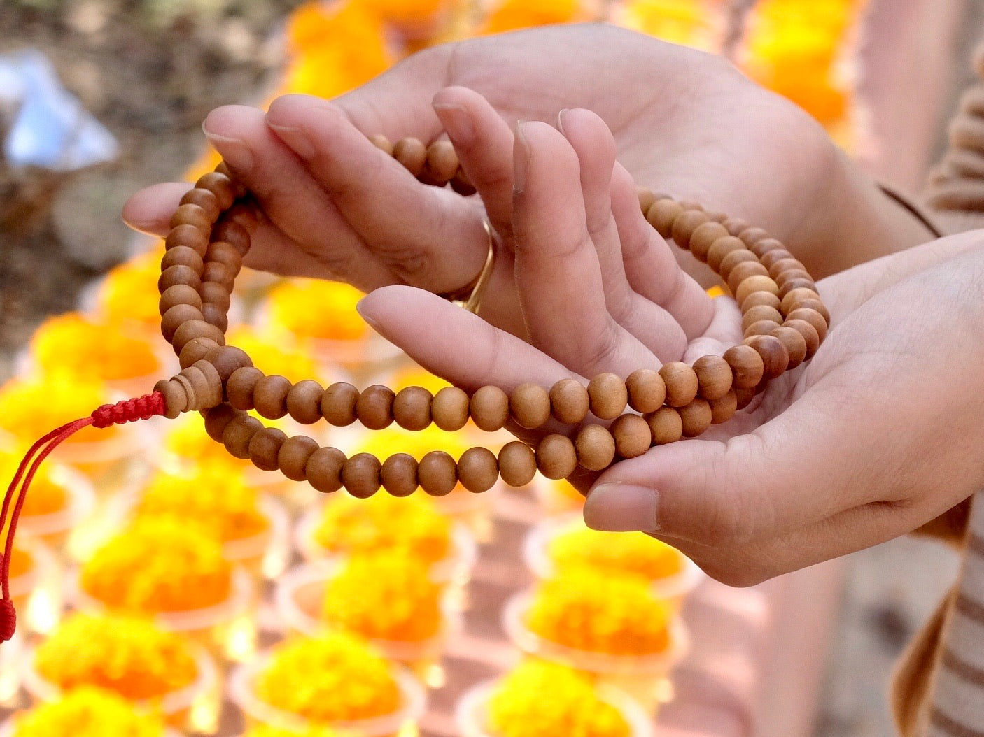 sandalwood mala beads on hand