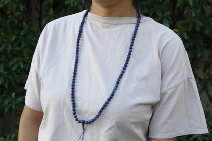 Lapis lazuli mala worn around neck 