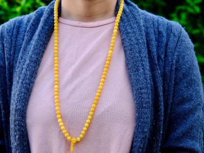 amber mala worn around Kunga's neck