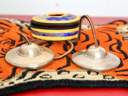 pair of 75 mm tingsha bells in front of case