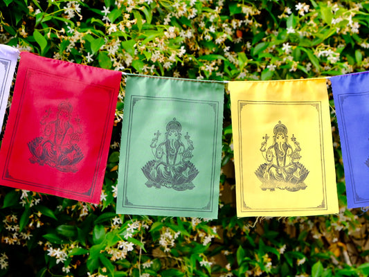 Ganesha prayer flags fluttering in garden.