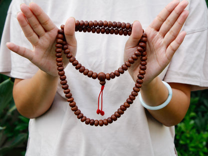 Bodhi seed mala wrapped twice around hands