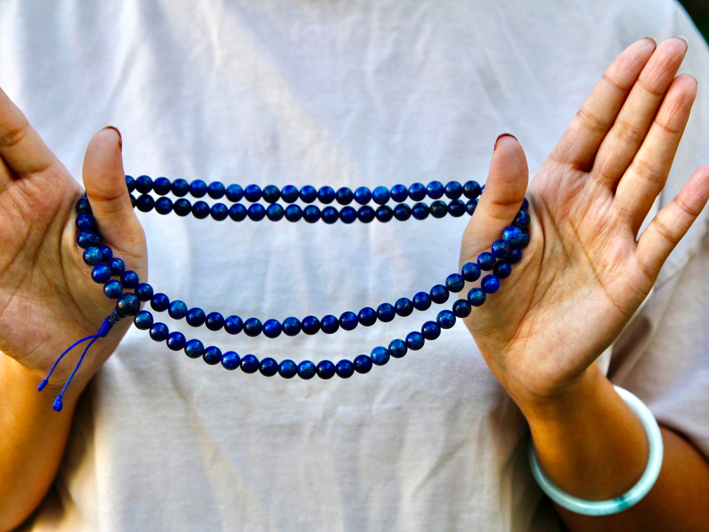 Lapis mala strung around hands and looped