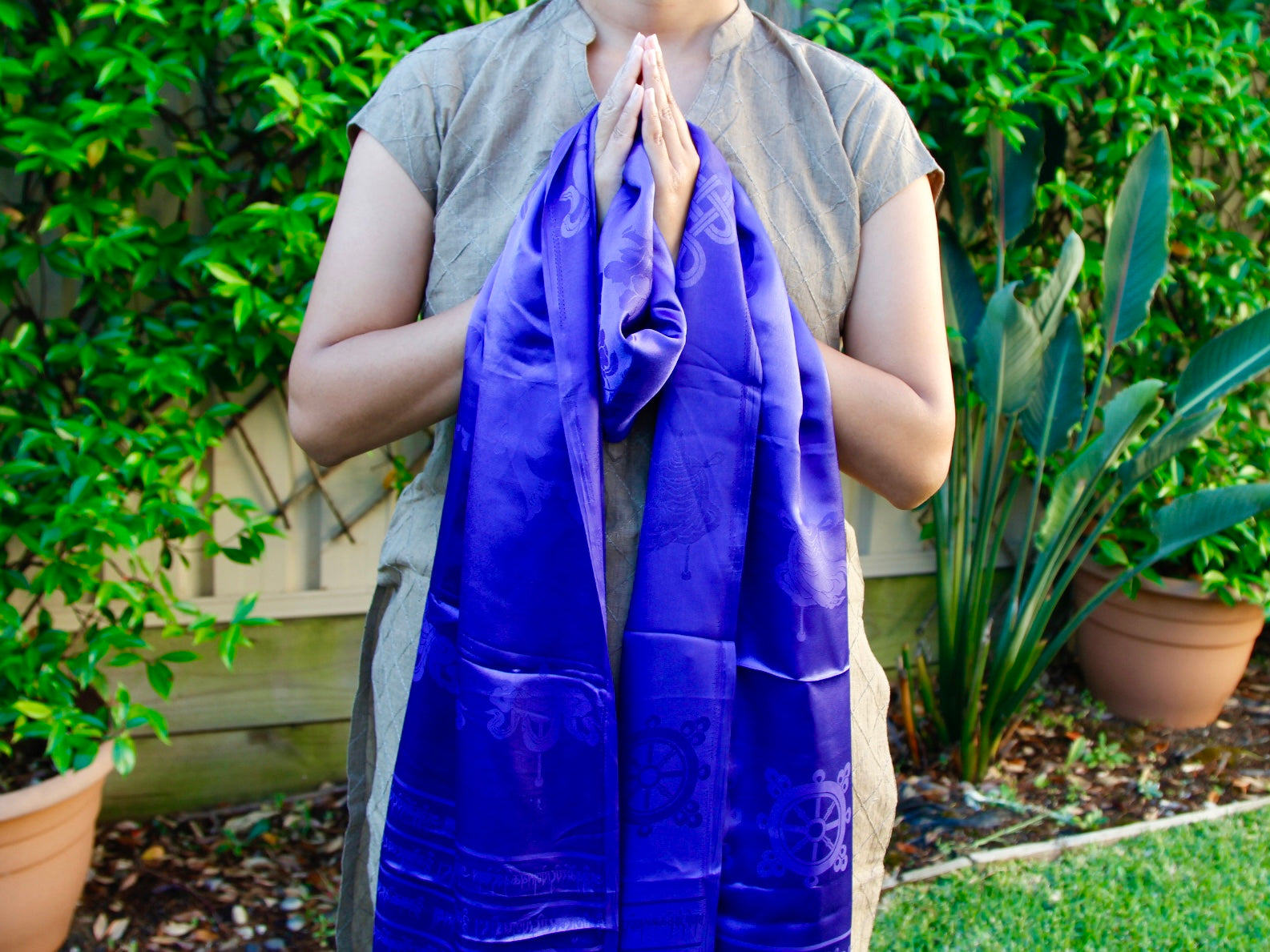 Blue khata khada Tibetan scarf held in Welcome gesture