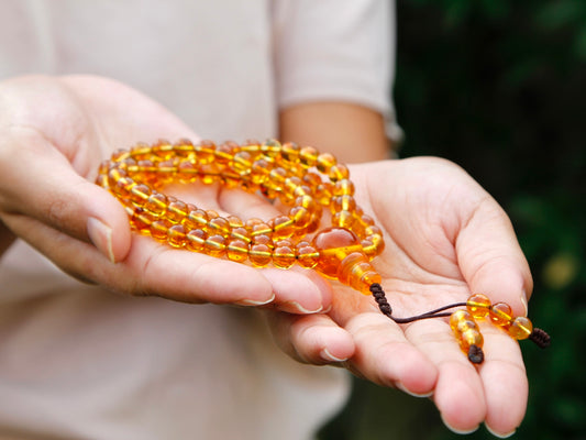 Honey amber mala with 108 beads in hand