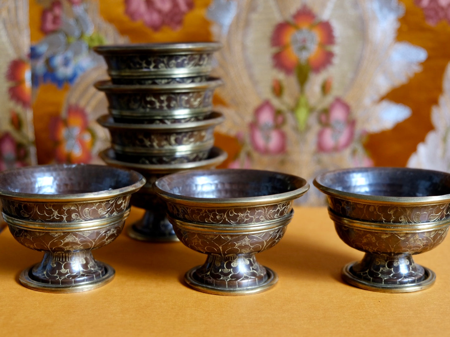 Set of 7 copper bowls with stand at altar.