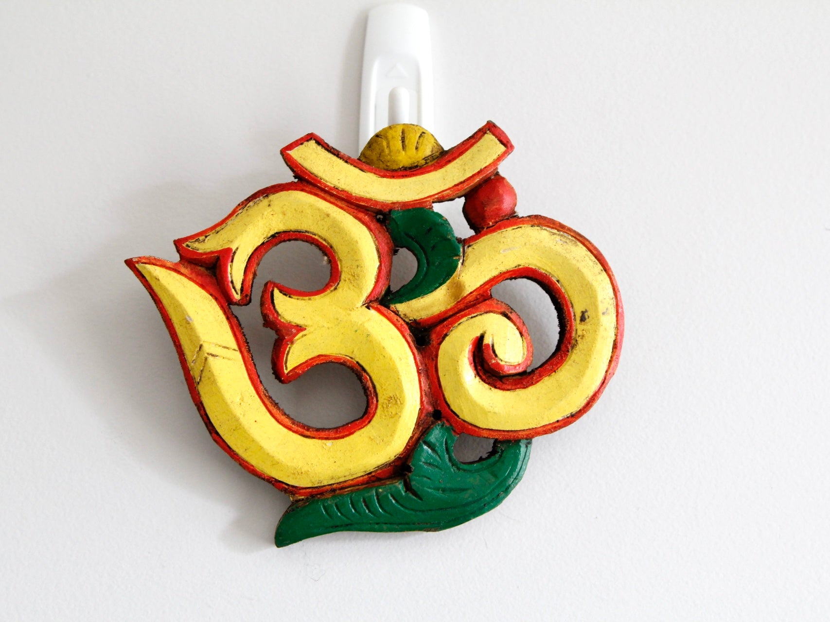 Yellow variant of Om wooden wall hanging