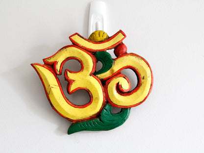 Yellow variant of Om wooden wall hanging