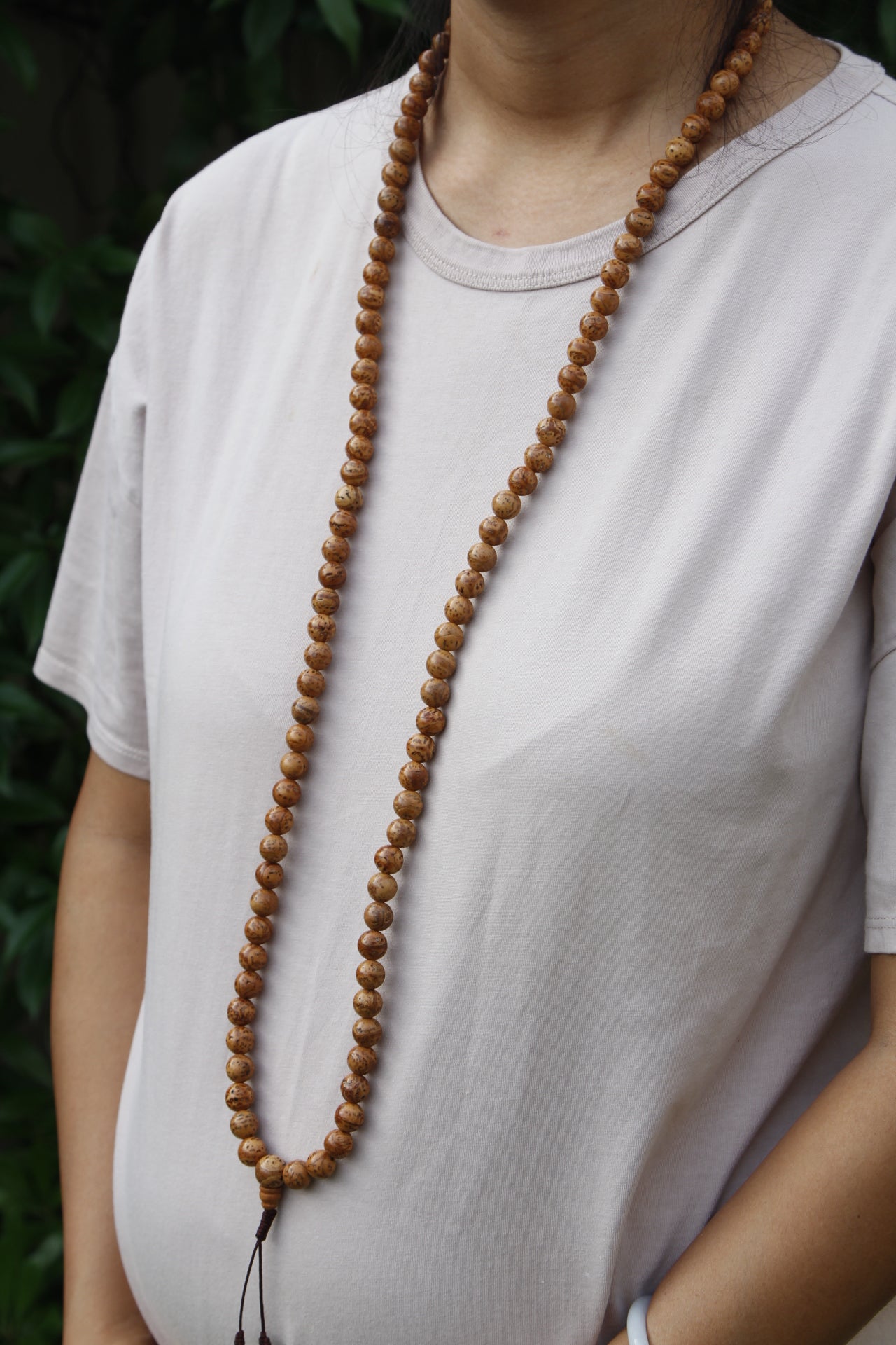 Portrait photo demonstrating length of Bodh Gaya Bodhi seed mala