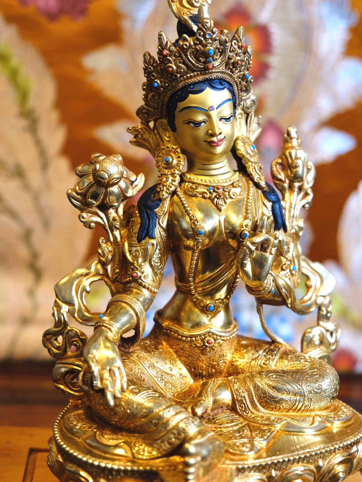 Portrait photo showing details in Tara statue (gold plated)