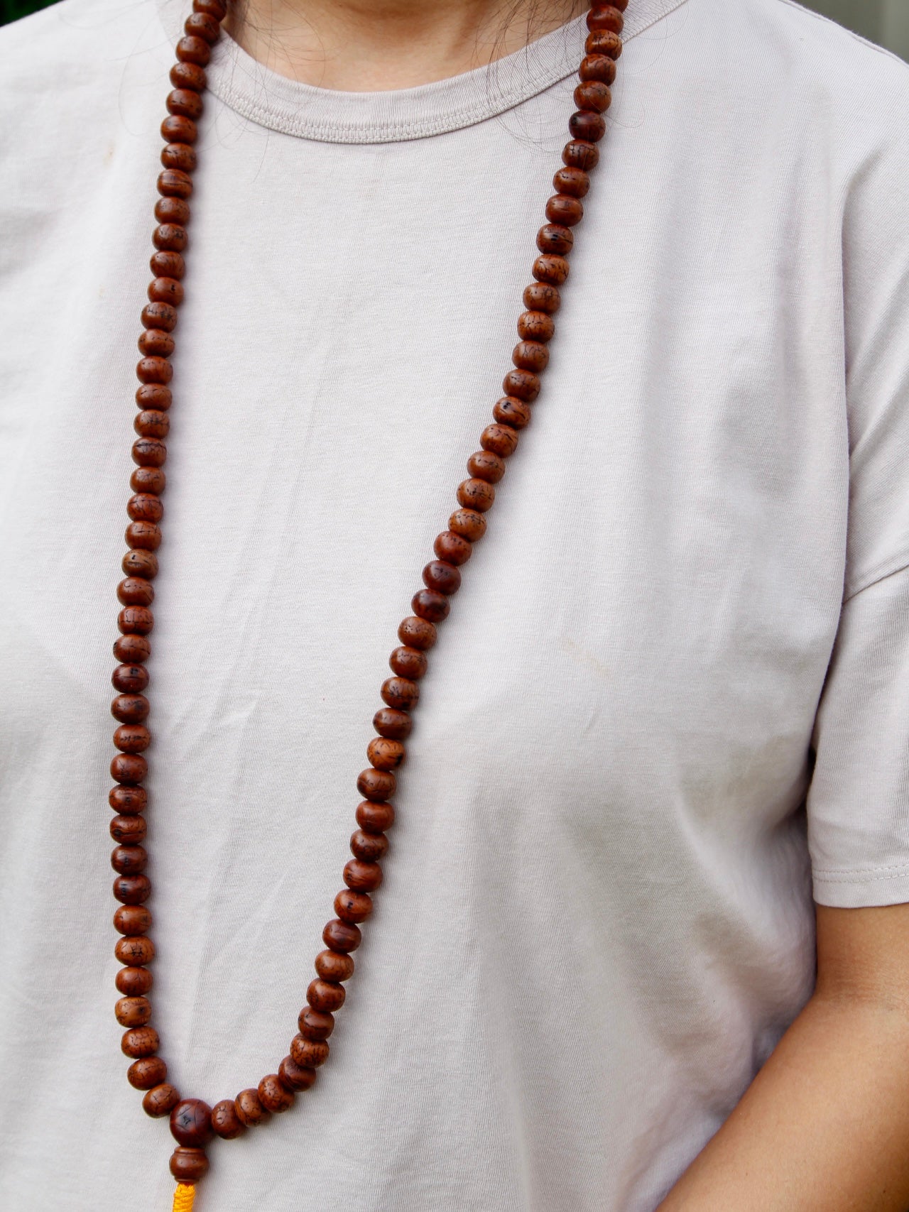 Bodhi seed mala worn around neck 