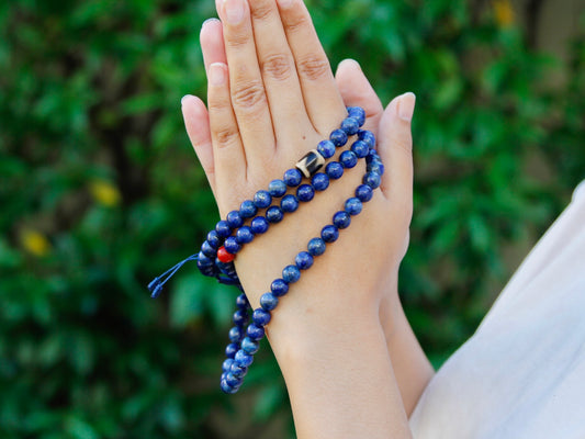 Custom lapis lazuli mala with 108 beads showing dzi and coral