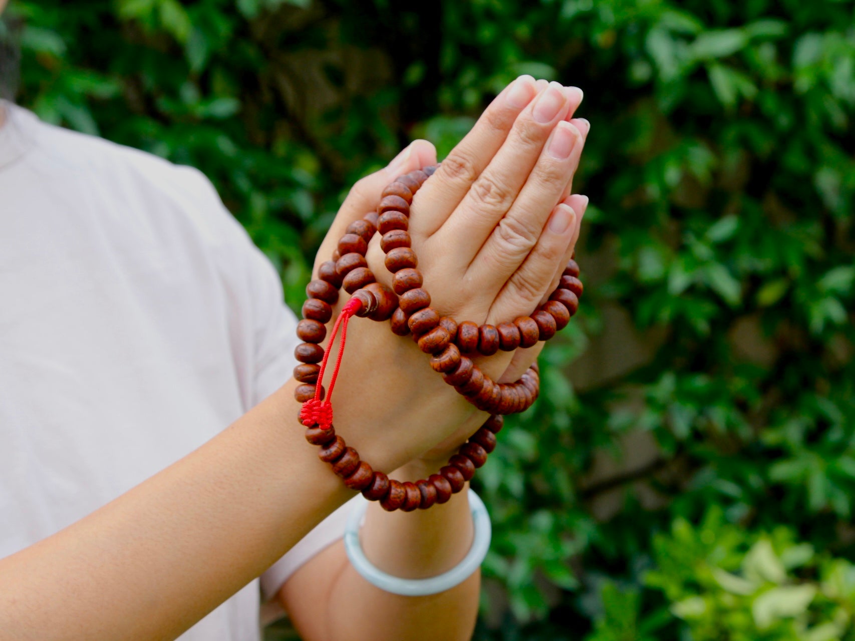 Bodhi Seed mala in namaste gesture hands