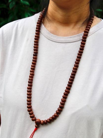 Short bodhi seed mala worn on Kunga's necl